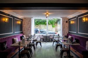 a dining room with tables and chairs and a window at The Psalter in Sheffield