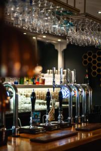 a bar with a counter with two sinks and glasses at The Psalter in Sheffield +14 photos