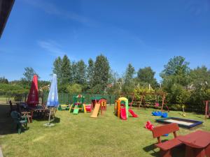 a park with a playground with tables and play equipment at Noce i dnie in Białogóra