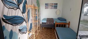 a room with a bunk bed and a ladder at Hostel Casarão do Surf in Bertioga