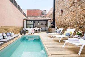 un patio con piscina, sillas y mesa en Home Deco Marenya House Costa Brava, en La Tallada
