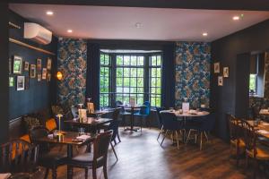 a dining room with tables and chairs and a window at The Psalter in Sheffield
