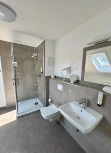 a bathroom with a toilet and a sink and a shower at Hotel Am Dom in Greifswald +42 photos