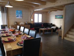 a dining room with a table and a living room at Chalet spacieux pour 10 personnes avec parking et animaux admis - FR-1-467-71 in Le Grand-Bornand +8 photos