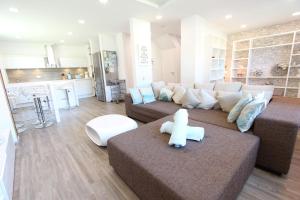 a living room with a brown couch and a kitchen at Ferienhaus Stefanie 1 in Langeoog