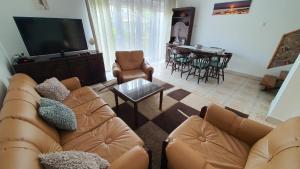 a living room with a couch and a tv and a table at Holiday home in Balatonlelle 38068 in Balatonlelle