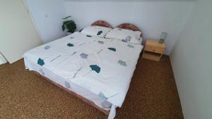 a bed with a white comforter and pillows on it at Holiday home in Balatonlelle 38068 in Balatonlelle +34 photos