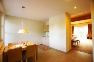 a kitchen and dining room with a table and chairs at Landhotel Sanct Peter in Bad Neuenahr-Ahrweiler