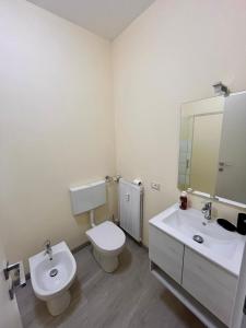 a bathroom with a toilet and a sink and a mirror at La Plata in Desenzano del Garda