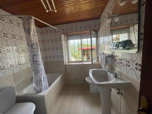 a bathroom with a sink and a tub and a toilet at La Casina de Castiello in Castiello +30 photos