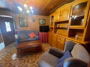 a living room with two couches and a table at La Casina de Castiello in Castiello