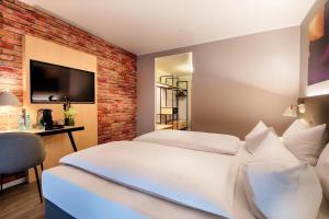 Postel nebo postele na pokoji v ubytování Offenbach Plaza Hotel