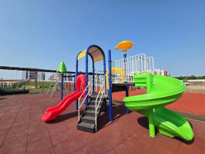 a playground with a slide and a slideintend at Sika Prestige Apartment - cazare premium Arad - self check-in in Arad