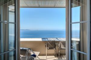 a view of the ocean from the balcony of a condo at Hôtel La Villa Douce in Rayol-Canadel-sur-Mer