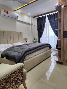 a bedroom with two beds and a window at Airport Transit Lodge in Islamabad