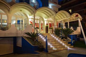 a lobby with stairs in a building with lights at Hotel Ambassador in Grottammare