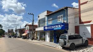a car parked in front of a building on a street at Rodrigues AP Apartamento em Barreirinhas in Barreirinhas
