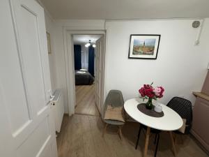 a room with a table with a vase of flowers on it at Sweet-Bombon Sibiu in Sibiu