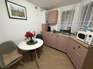 a small kitchen with a table and a microwave at Sweet-Bombon Sibiu in Sibiu +6 photos