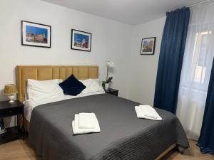 a bedroom with a bed with two towels on it at Sweet-Bombon Sibiu in Sibiu