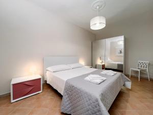 a bedroom with a large white bed with a red drawer at Al Giardino del Pepe in Lanciano