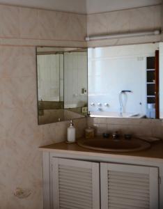 a bathroom with a sink and a mirror at Little B&B Della Pieve in Panzano