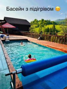 a person in a pool with a raft in the water at Georgiy in Oryavchyk