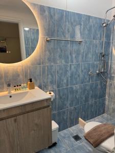 a bathroom with a sink and a mirror at Corali Luxury Beach Apartment in Poros