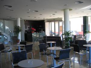 a room with tables and chairs in a building at Hotel SG in Bullas