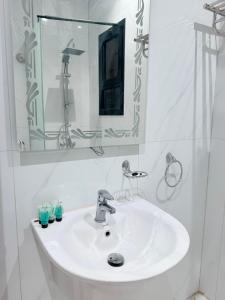 a bathroom with a white sink and a mirror at استديو نايف 1 in Medina +23 photos