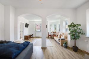 a white room with a bed and a living room at Villa Romantika in Ichenhausen