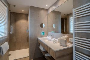 a bathroom with a sink and a shower at Hôtel La Villa Douce in Rayol-Canadel-sur-Mer