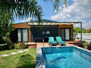 a house with a swimming pool in a yard at SB GREEN GARDEN in Ortaca