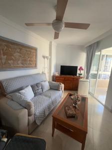 a living room with a couch and a table at Estudio MAR EN CALMA, Primera Línea de Playa con Vistas al Mar in Torrox