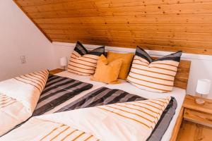 a bedroom with two beds with pillows on it at Ferienwohnung Alte Schneiderei in Heideck