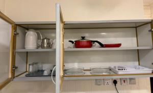 a cupboard with a tea pot and dishes on it at توارن عنيزة in Riyadh