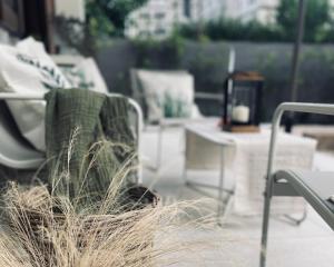 a chair sitting on a patio with some tall grass at Flos in Cassino +38 photos