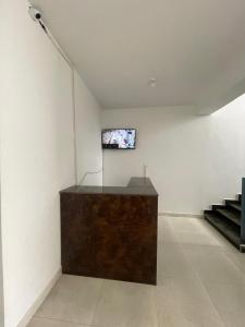 a white room with a television on a wall at Roof Top Homestay in Leh +20 photos