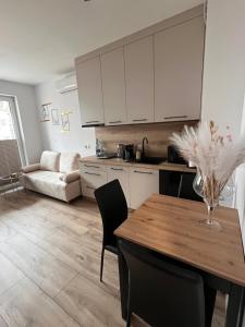 a kitchen with a table and chairs and a couch at Apartament Sukces in Biała Podlaska