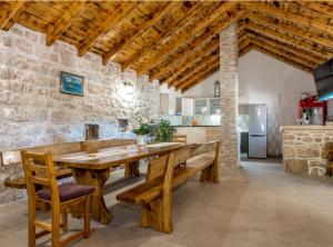 a large dining room with a wooden table and benches at Holiday Home Stari Dvori in Šibenik +23 photos