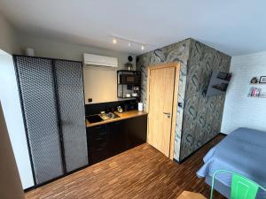 a small room with a kitchen and a door at Różana Loft - Old Town in Kraków