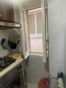 a small kitchen with a sink and a window at residence Gaja in Gaeta
