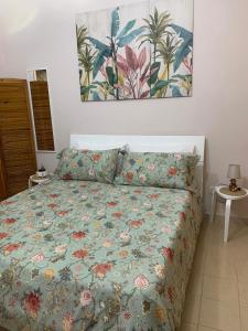 a bedroom with a bed with a colorful comforter at residence Gaja in Gaeta