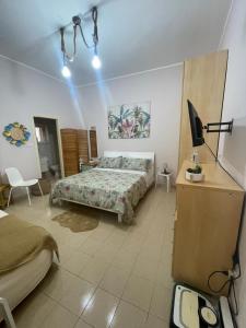 a bedroom with a bed and a tv in it at residence Gaja in Gaeta