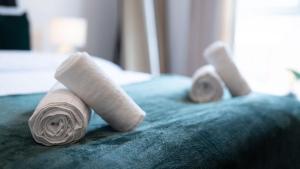 two rolled up towels on top of a bed at Luxury 1-bed Near MCR Hospital & City Centre in Manchester