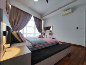 a bedroom with a large bed with a window at 4 Rooms 7 Beds 4 Baths at KLSunwayPJ in Petaling Jaya
