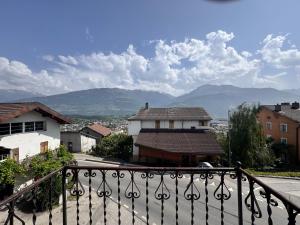 a view of a town from a balcony of a house at appartement Valentine au coeur des 4 Vallées in Conthey