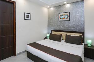 a bedroom with a large bed in a room at Super Hotel O The Signature Inn in Indirapuram