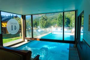 a view of a swimming pool through a window at Las Rocas By Base 41 in San Carlos de Bariloche