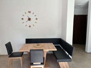 a dining room with a table and chairs and a clock at Auszeit in Schwaigern in Schwaigern